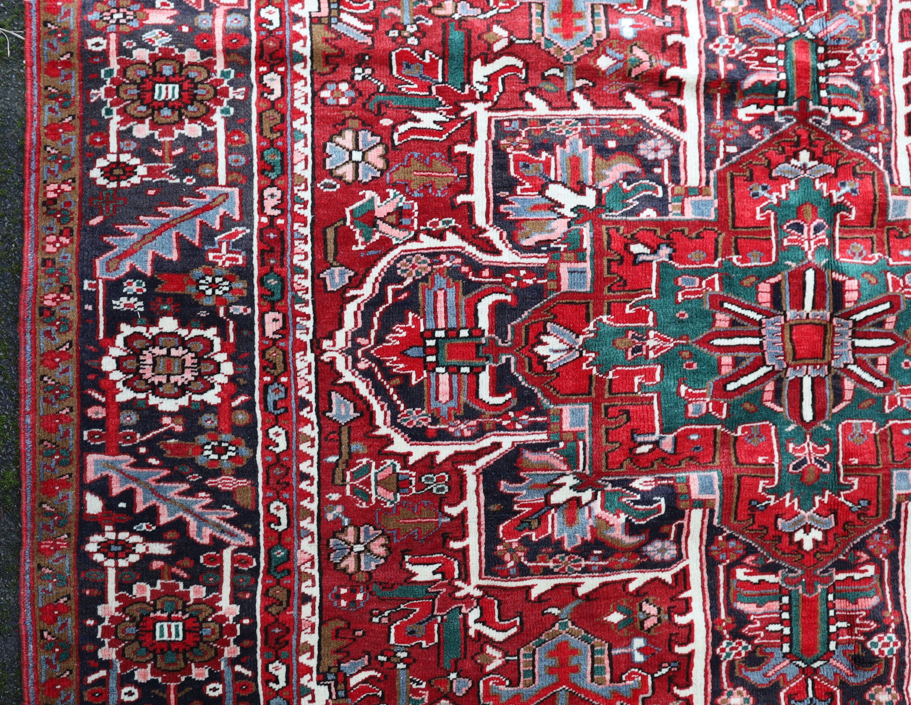 A Heriz red ground carpet, 324 x 243cm.